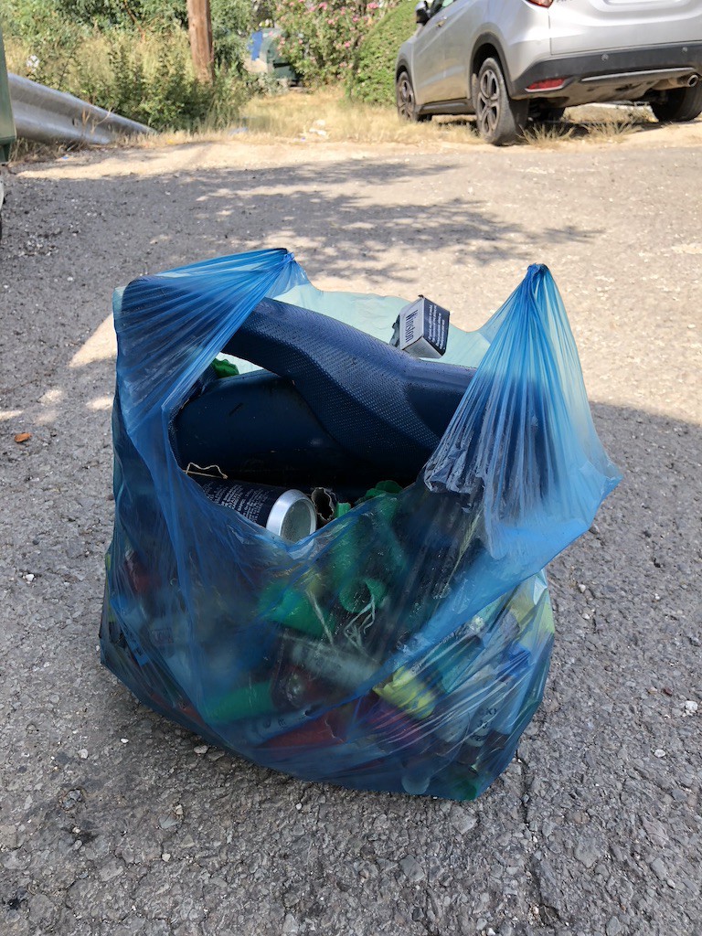 Bag full of shotgun shells, oil canister and other garbage
