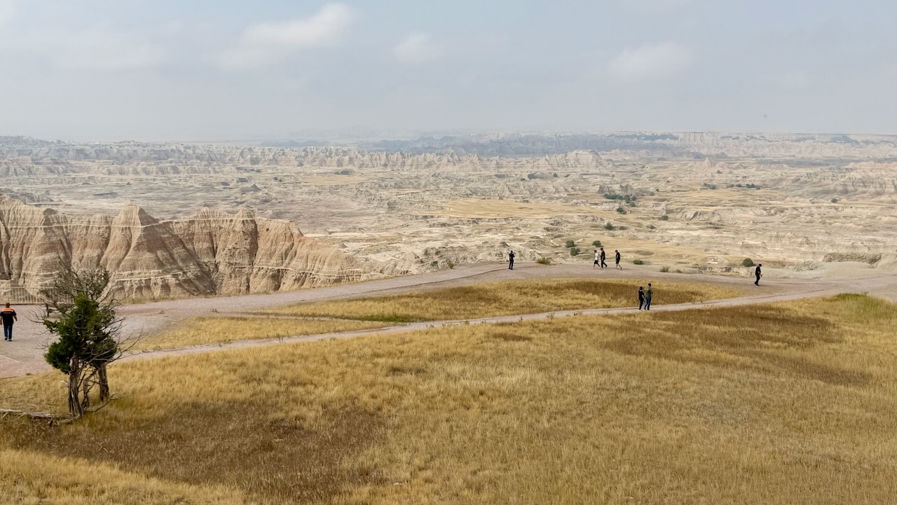 Overlook of the Badlands with visitors on the trail